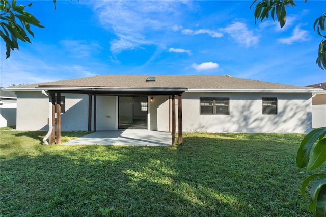 back of property featuring a yard and a patio area