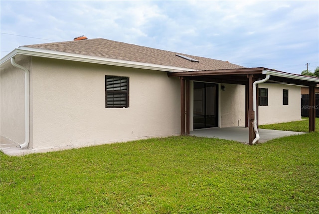 back of property featuring a patio and a lawn