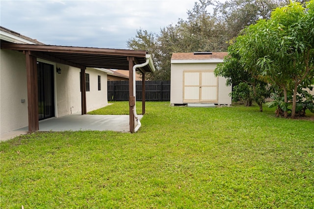 view of yard featuring a patio and a shed