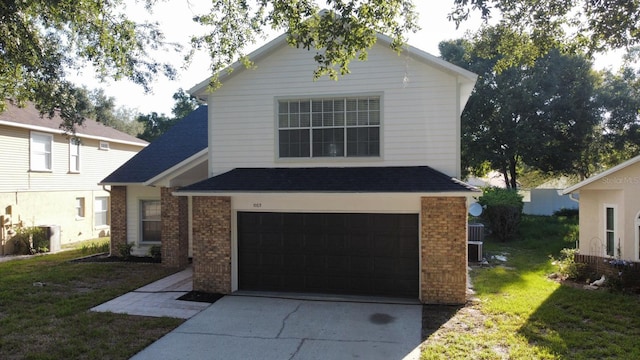 front facade with a garage and a front lawn