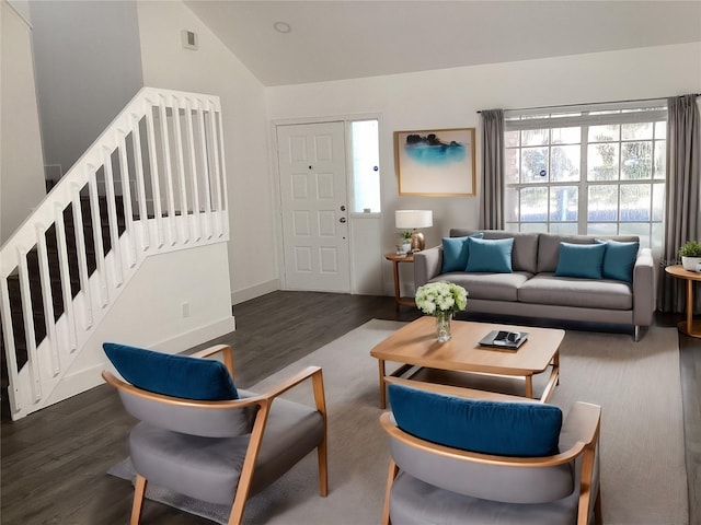 living room featuring vaulted ceiling, a healthy amount of sunlight, and dark hardwood / wood-style floors