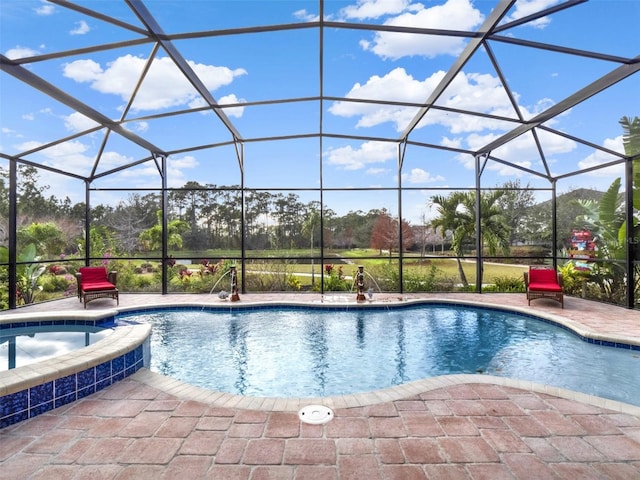 view of pool with an in ground hot tub, a patio, and glass enclosure