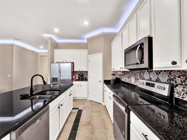 kitchen with stainless steel appliances, a sink, visible vents, and white cabinets