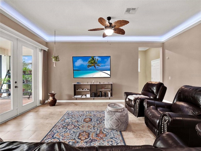 living room with visible vents, a ceiling fan, and french doors