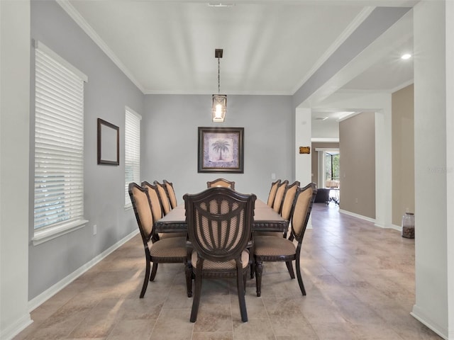 dining space featuring baseboards and crown molding