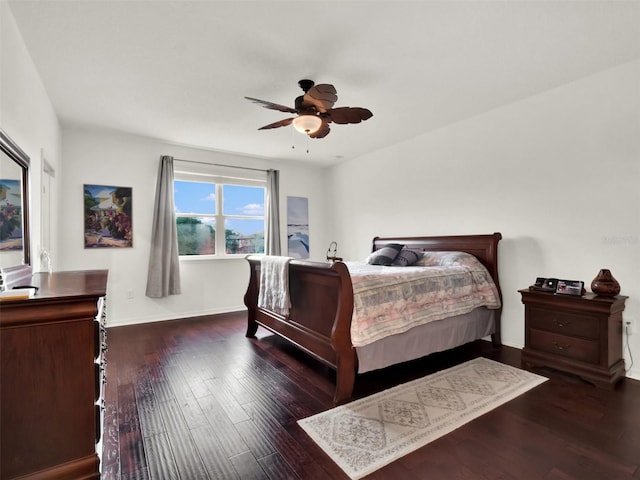 bedroom featuring ceiling fan, wood finished floors, and baseboards