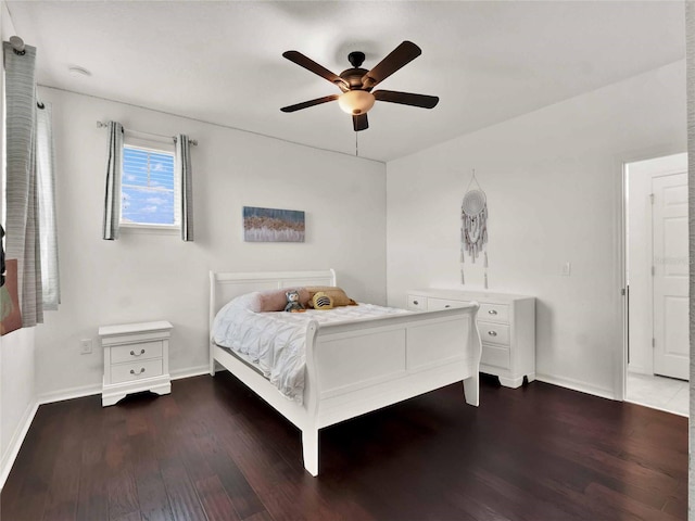 bedroom featuring a ceiling fan, baseboards, and wood finished floors