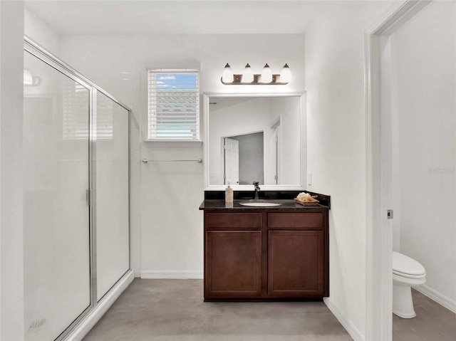 full bathroom with baseboards, a shower stall, toilet, and vanity