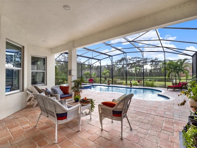 view of swimming pool with glass enclosure, a patio area, and a pool with connected hot tub