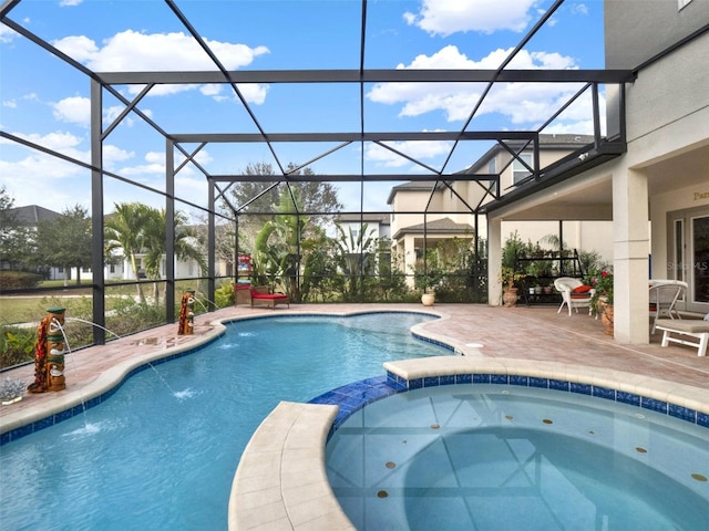 view of pool with a pool with connected hot tub, a patio, and a lanai