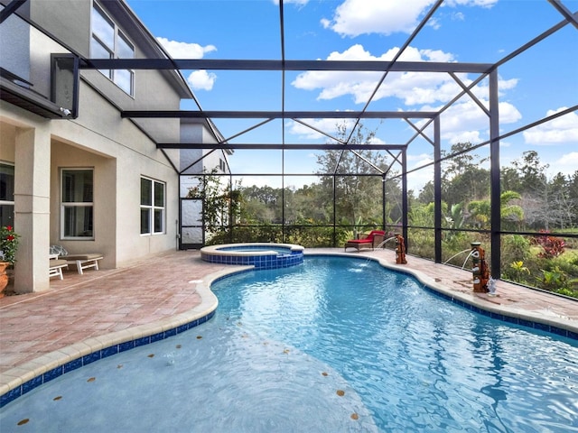 view of pool with a pool with connected hot tub, glass enclosure, and a patio