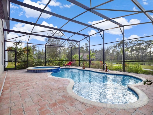 view of pool with glass enclosure, a patio area, and a pool with connected hot tub