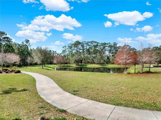 surrounding community featuring a water view and a yard