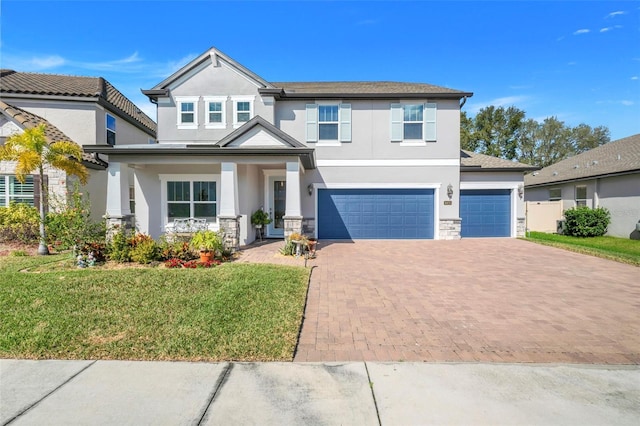 view of front of home featuring a garage, a porch, and a front yard