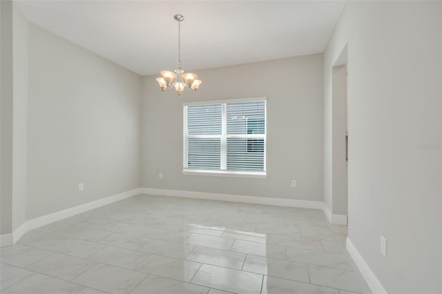 spare room featuring a notable chandelier