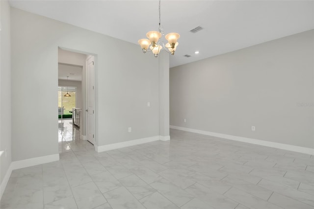 spare room featuring a notable chandelier