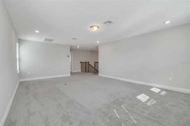 spare room with light colored carpet