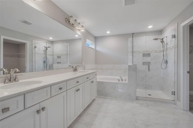 bathroom featuring vanity and shower with separate bathtub