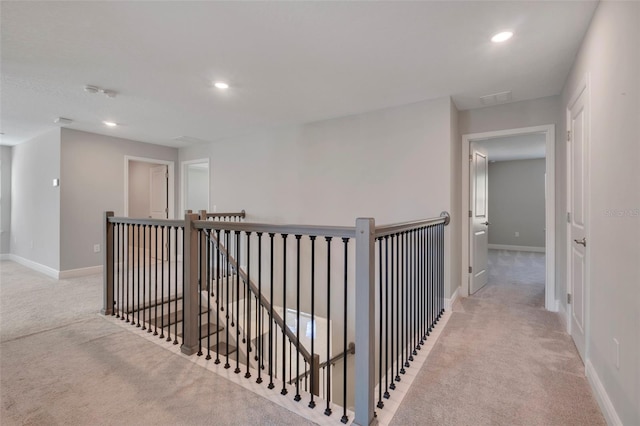 hallway featuring light colored carpet