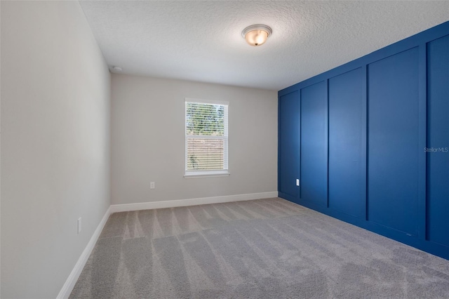 unfurnished bedroom featuring light carpet and a textured ceiling