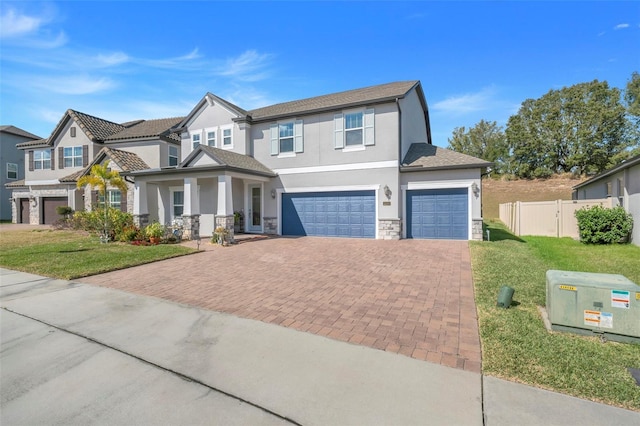 view of front of property featuring a garage and a front lawn