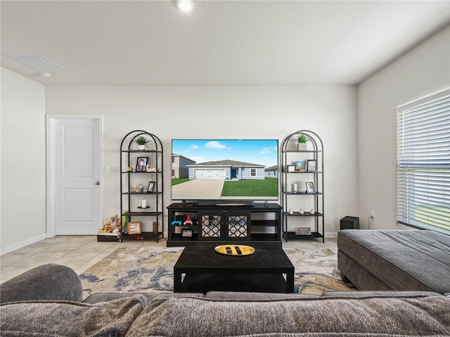 living room featuring light tile patterned floors and a textured ceiling