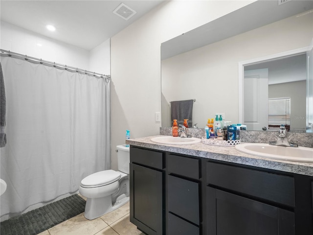 bathroom with vanity, curtained shower, tile patterned floors, and toilet