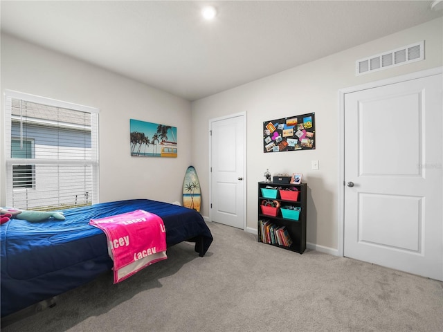 bedroom with light colored carpet