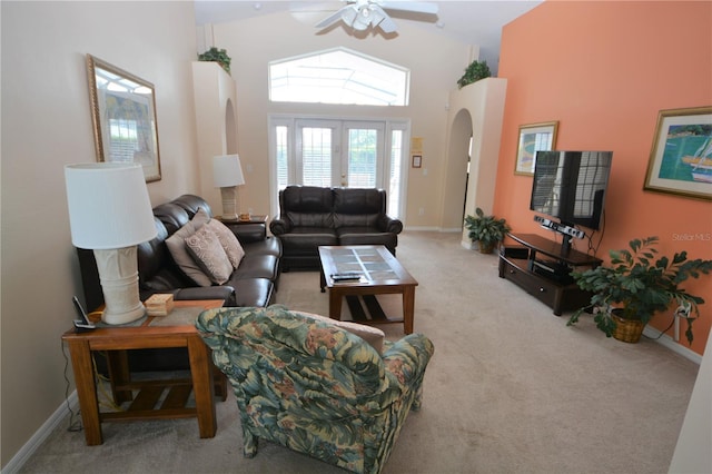 living room featuring french doors, light colored carpet, ceiling fan, and high vaulted ceiling