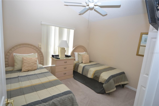 bedroom with vaulted ceiling, ceiling fan, and carpet floors