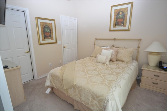 bedroom featuring light carpet