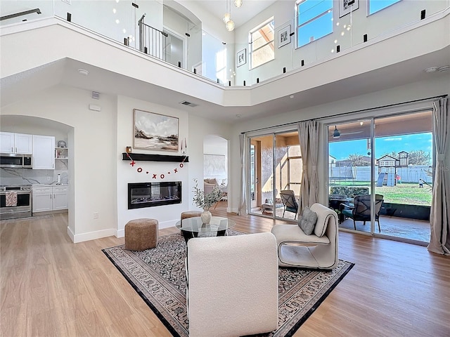 living room featuring light wood-type flooring and a wealth of natural light