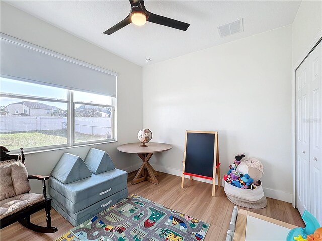 game room with ceiling fan and light hardwood / wood-style floors