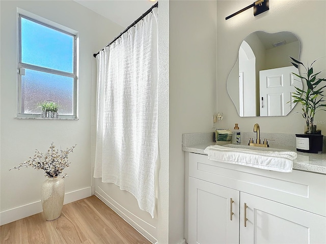 bathroom featuring shower / tub combo with curtain, vanity, and wood-type flooring