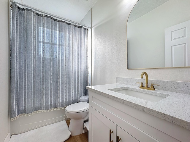 full bathroom with shower / tub combo with curtain, vanity, toilet, and hardwood / wood-style floors