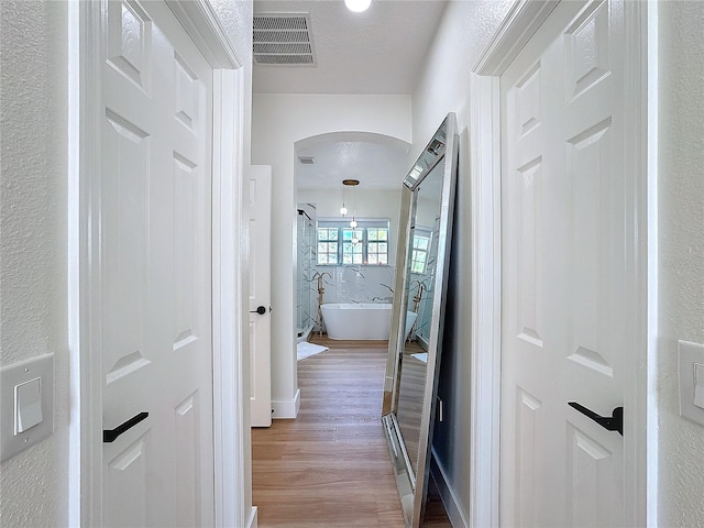 hallway featuring hardwood / wood-style flooring