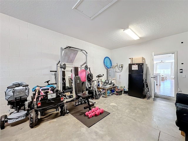 exercise room featuring a textured ceiling