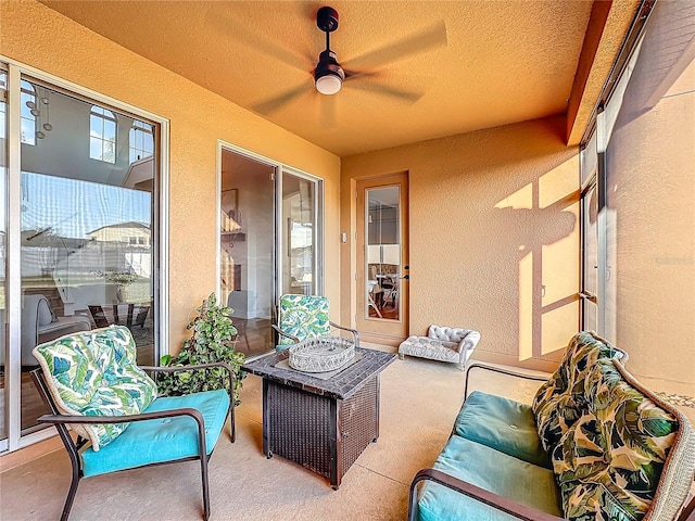 sunroom / solarium featuring ceiling fan