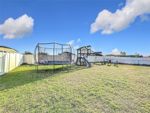 view of yard featuring a trampoline and a playground