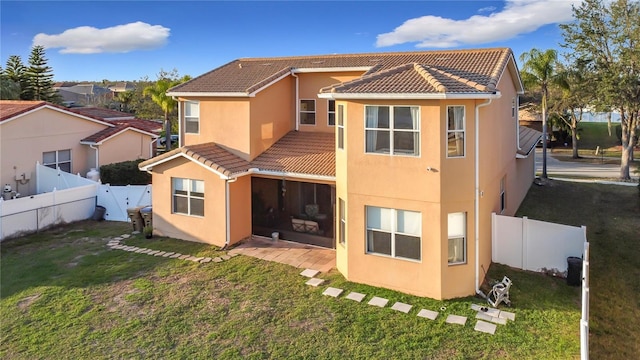 rear view of property with a lawn