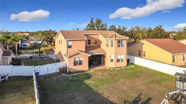 back of property with a patio and a lawn