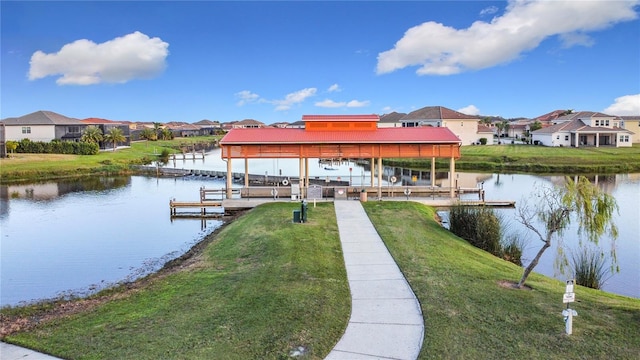 dock area with a water view and a lawn