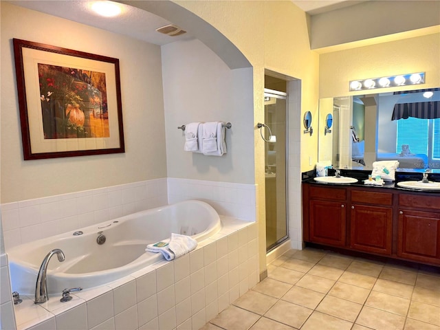 8100 Poinciana Blvd Unit B2/U2511, Orlando, FL 32821 - ensuite bathroom with tile patterned flooring, a shower stall, visible vents, double vanity, and a bath