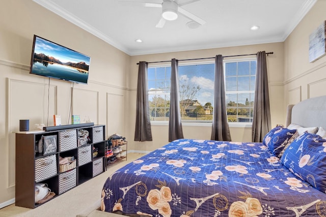 carpeted bedroom featuring crown molding and ceiling fan