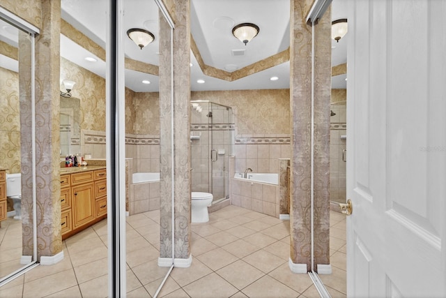 full bathroom with tile patterned floors, toilet, vanity, and tile walls