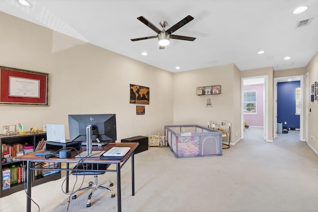 office featuring light carpet and ceiling fan