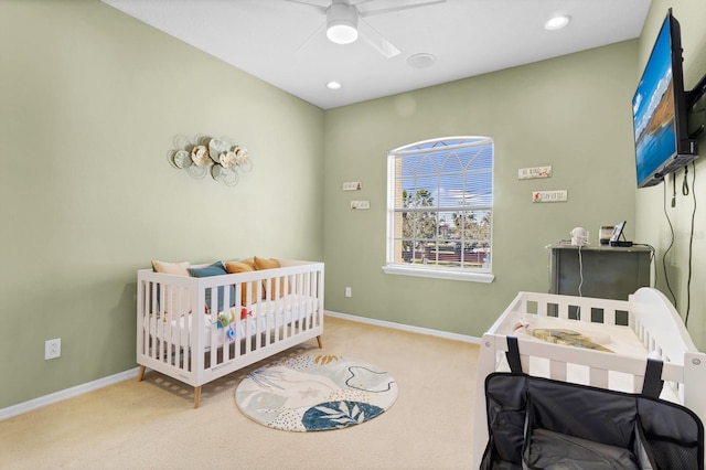 bedroom featuring light carpet and ceiling fan