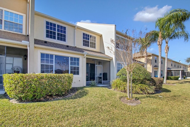 rear view of property featuring a yard