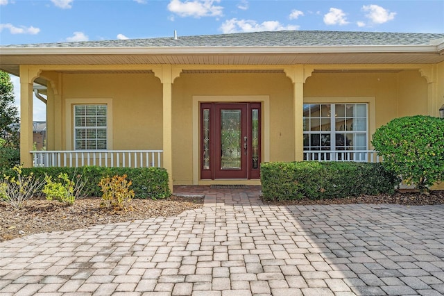 doorway to property with covered porch