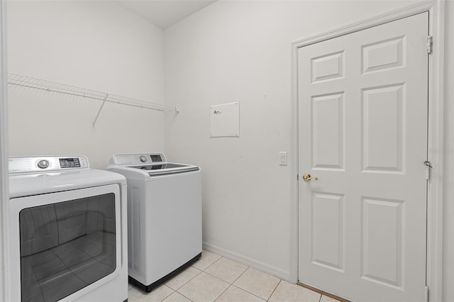 laundry area with light tile patterned flooring and independent washer and dryer